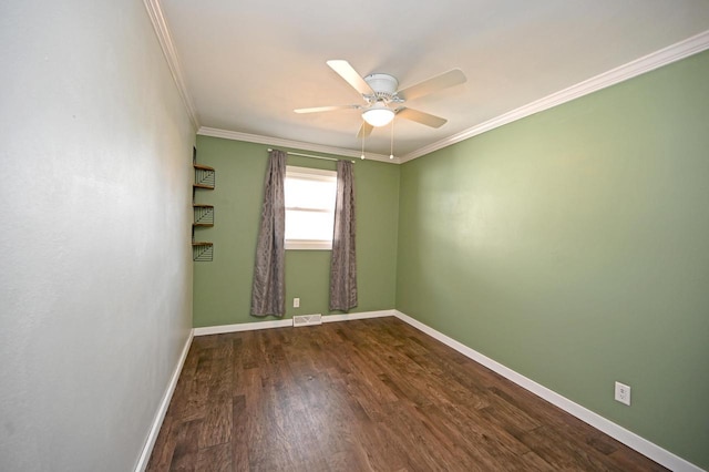 spare room with a ceiling fan, wood finished floors, visible vents, and ornamental molding