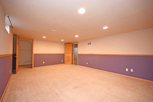 carpeted spare room featuring recessed lighting, visible vents, and baseboards