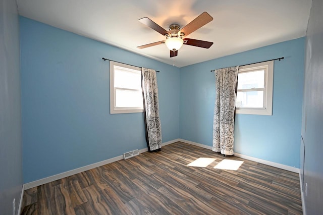 unfurnished room with visible vents, plenty of natural light, and baseboards