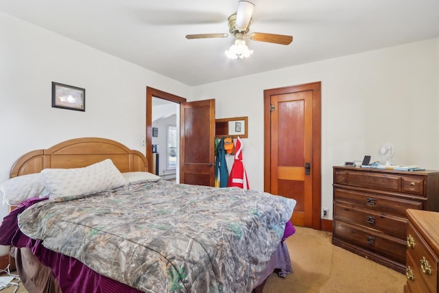 bedroom featuring light carpet and a ceiling fan