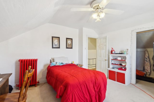 bedroom featuring radiator, a ceiling fan, lofted ceiling, and carpet floors