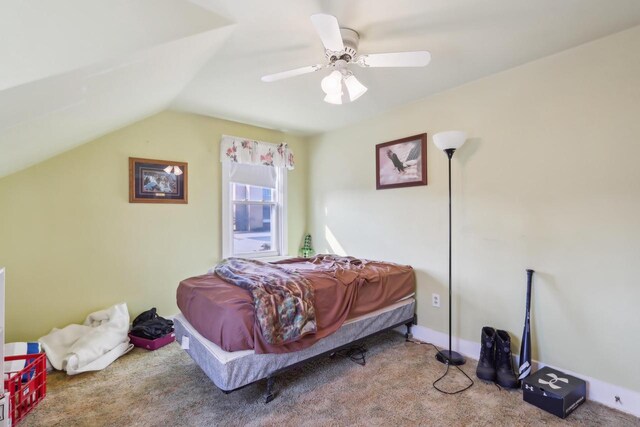 bedroom with lofted ceiling, ceiling fan, and carpet flooring