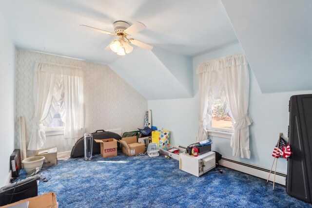 recreation room with wallpapered walls, carpet, ceiling fan, vaulted ceiling, and a baseboard radiator