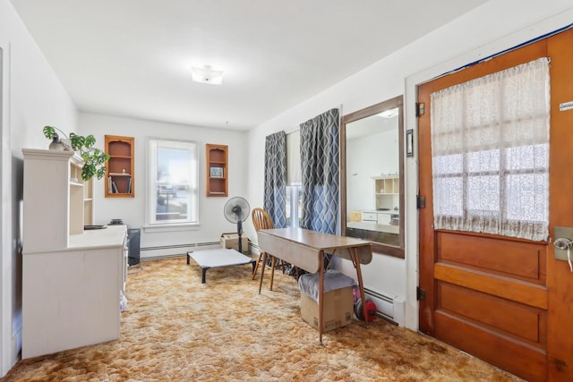 carpeted home office featuring a baseboard heating unit