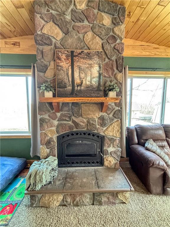 living area with a fireplace and wood ceiling