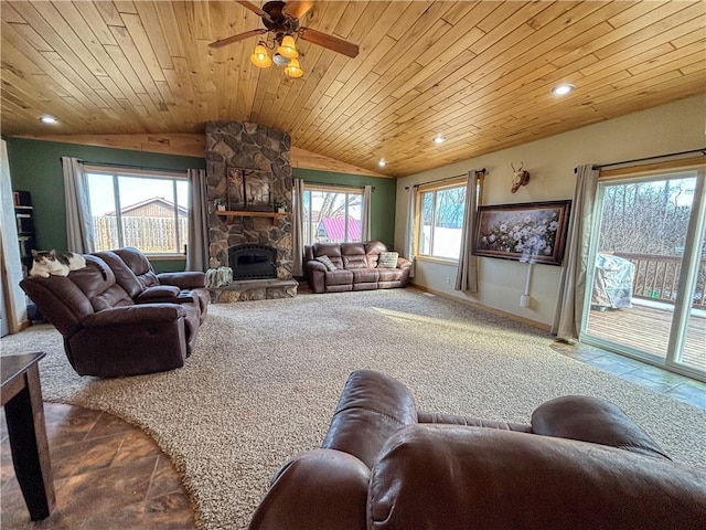 living room with a ceiling fan, wooden ceiling, a fireplace, baseboards, and vaulted ceiling