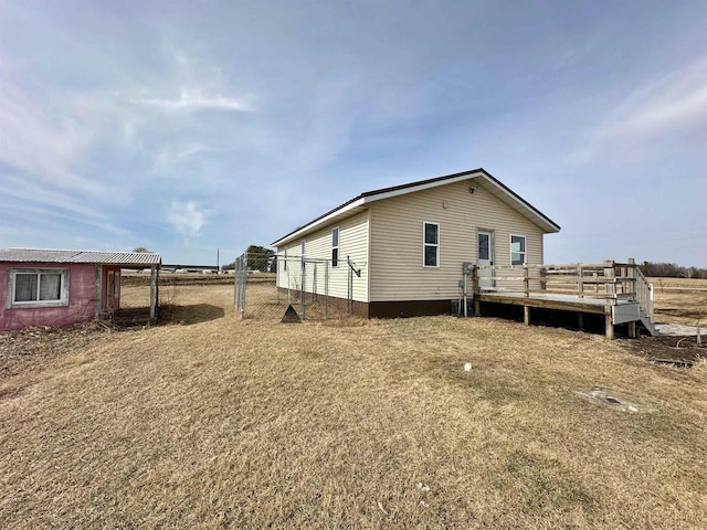 exterior space featuring fence and a wooden deck