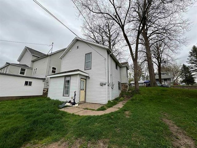 back of property featuring a lawn