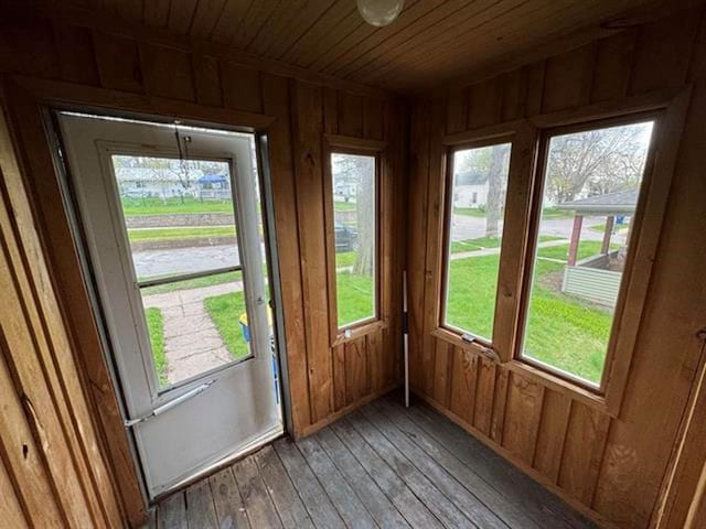 unfurnished sunroom with a healthy amount of sunlight and wooden ceiling