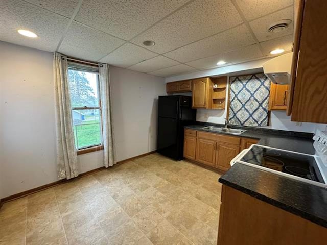 kitchen with open shelves, freestanding refrigerator, electric range oven, a sink, and dark countertops