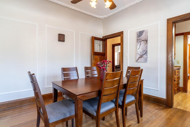 dining room featuring baseboards, light wood-style floors, and ceiling fan