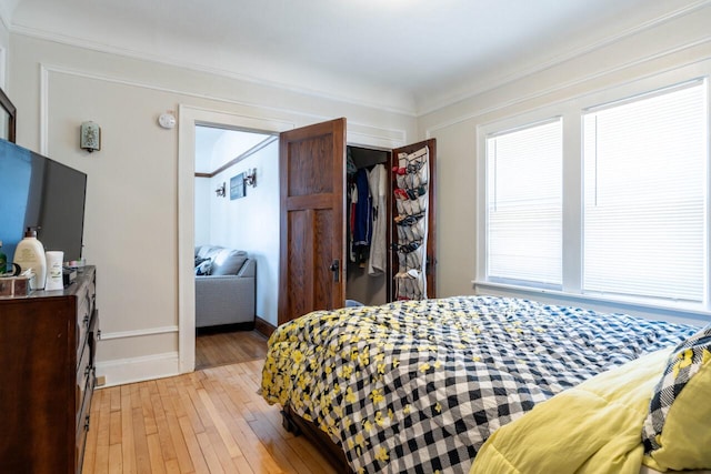 bedroom with light wood-style flooring and baseboards