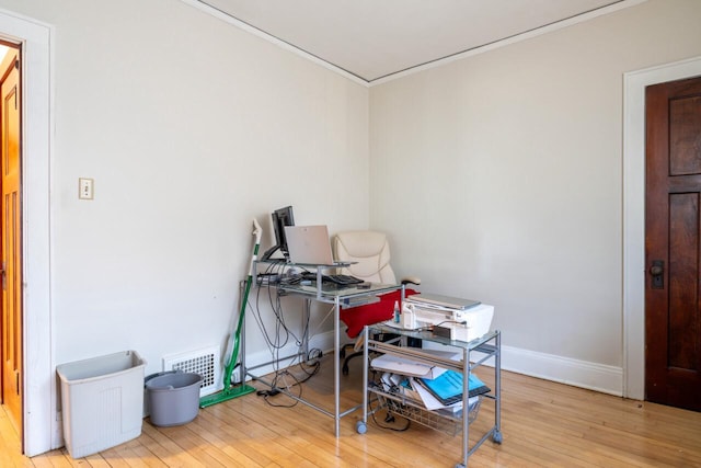 misc room featuring hardwood / wood-style flooring, baseboards, and visible vents