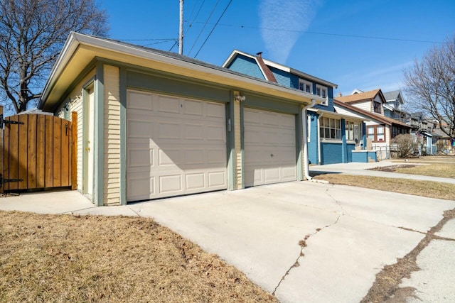 view of front of home featuring a residential view, fence, and a gate