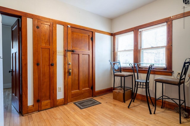 entryway with light wood-style floors, visible vents, and baseboards