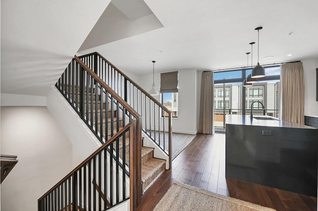 staircase with hardwood / wood-style floors