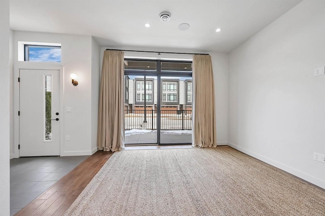 entryway with recessed lighting, a healthy amount of sunlight, and baseboards