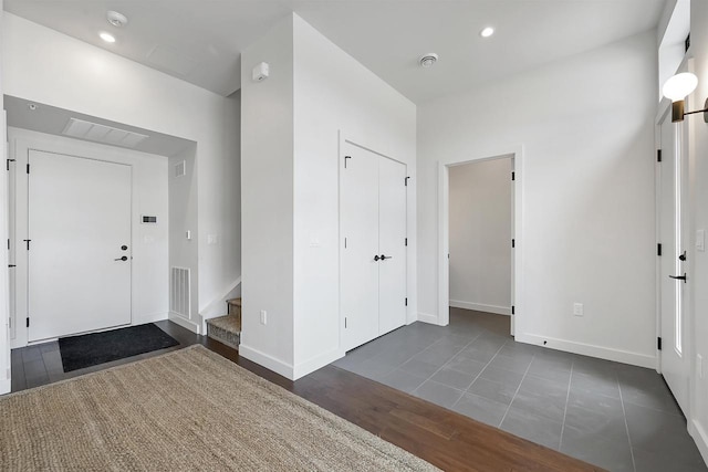 entrance foyer with visible vents, wood finished floors, recessed lighting, stairway, and baseboards