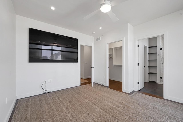 unfurnished bedroom featuring visible vents, a walk in closet, baseboards, recessed lighting, and a closet