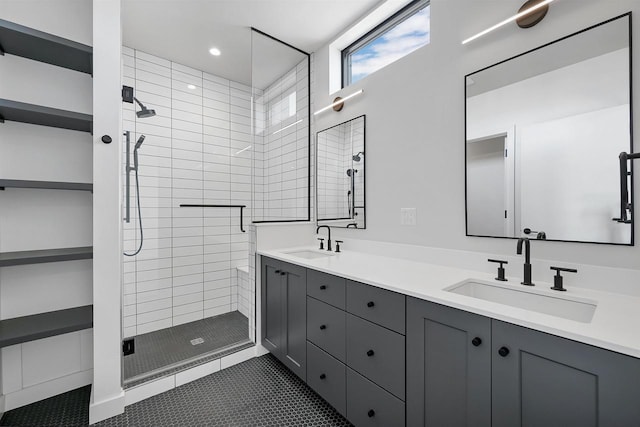 bathroom featuring double vanity, tile patterned floors, a stall shower, and a sink