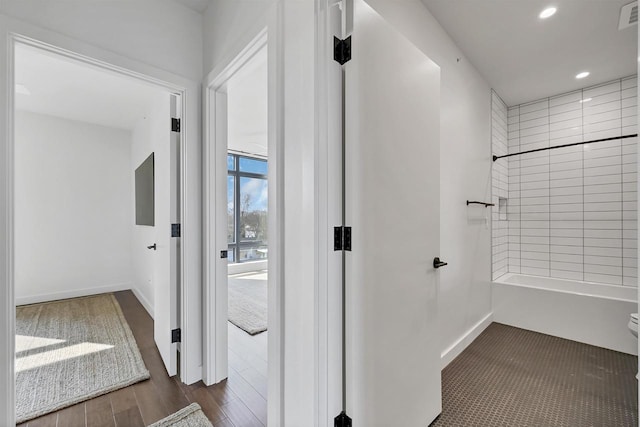 hallway with visible vents, recessed lighting, baseboards, and wood finished floors