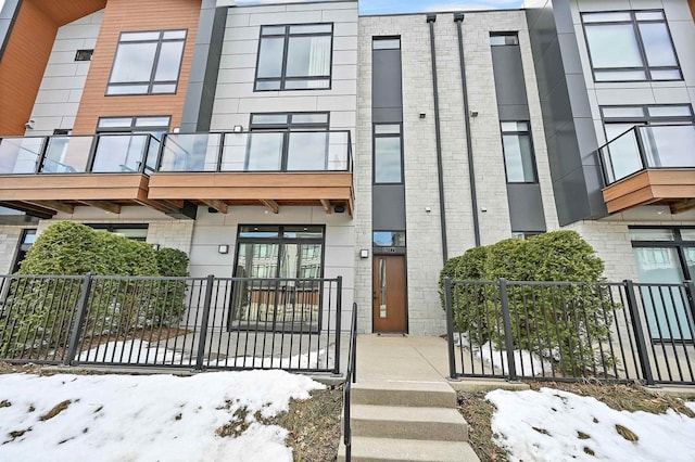 exterior space with fence and brick siding