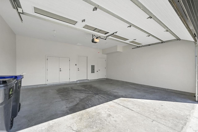 garage featuring electric panel and a garage door opener