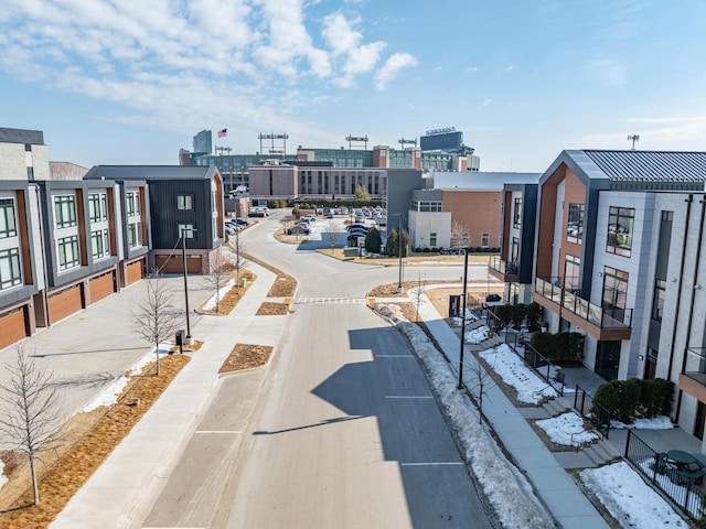 view of road featuring a city view, curbs, and sidewalks