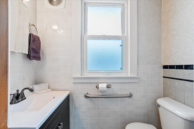 bathroom featuring a wealth of natural light, toilet, and tile walls