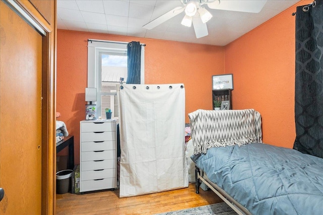 bedroom featuring a ceiling fan and wood finished floors