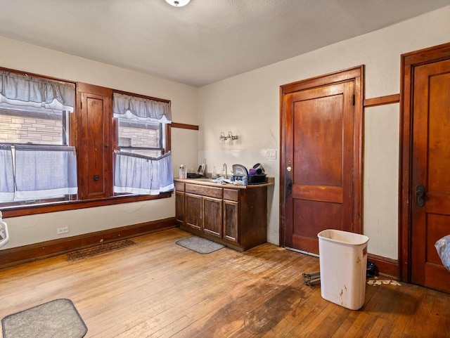 interior space with visible vents, light wood-style floors, and baseboards