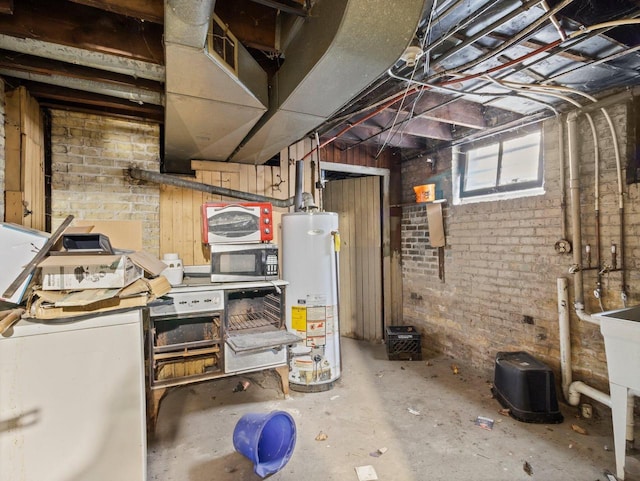 basement featuring gas water heater and brick wall