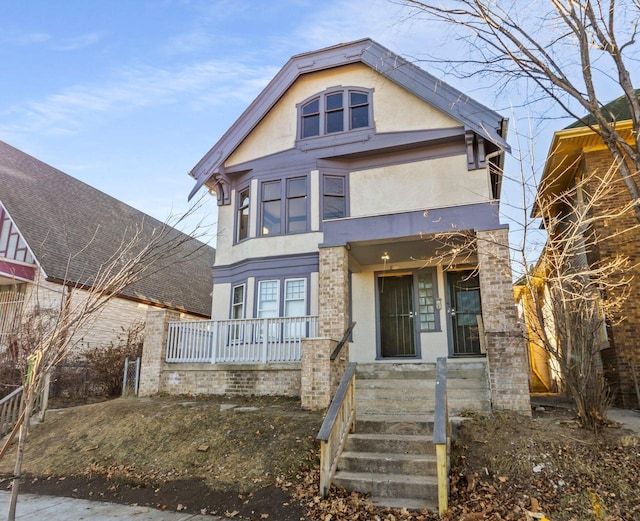 view of front of house with stucco siding and a porch