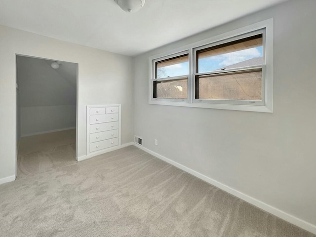 unfurnished bedroom with carpet, visible vents, and baseboards