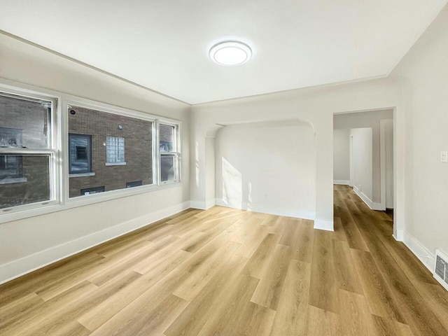 spare room with light wood-style flooring and baseboards