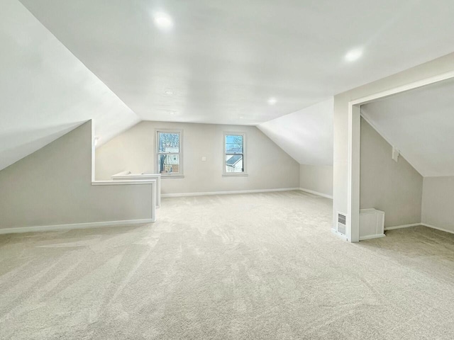 bonus room with carpet flooring, baseboards, and lofted ceiling