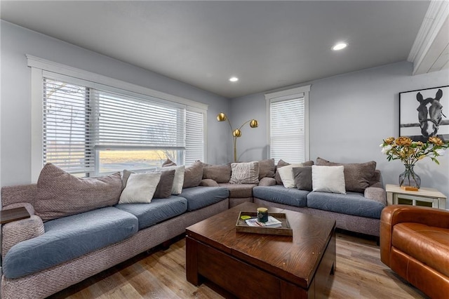 living room with light wood finished floors and recessed lighting