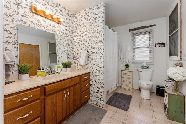 bathroom featuring tile patterned floors, toilet, wallpapered walls, and vanity