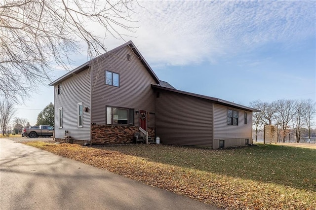 view of side of home with a yard