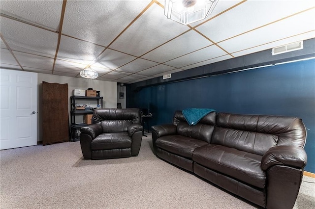 living area featuring a paneled ceiling, visible vents, and carpet floors