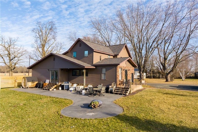 back of house featuring a yard, roof with shingles, a patio, and fence