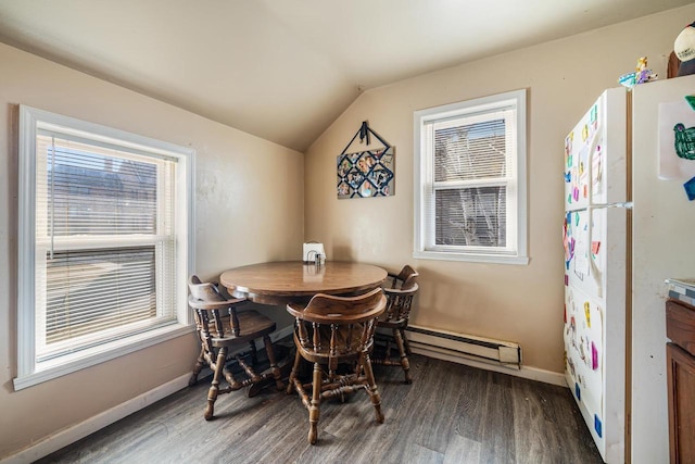 dining room with baseboards, lofted ceiling, baseboard heating, and wood finished floors