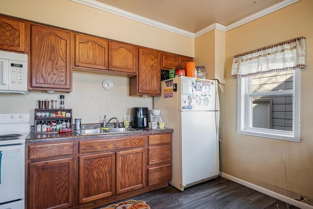 kitchen featuring a sink, white appliances, ornamental molding, and brown cabinetry