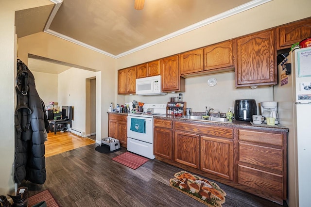 kitchen with dark wood-type flooring, a sink, white appliances, brown cabinetry, and crown molding