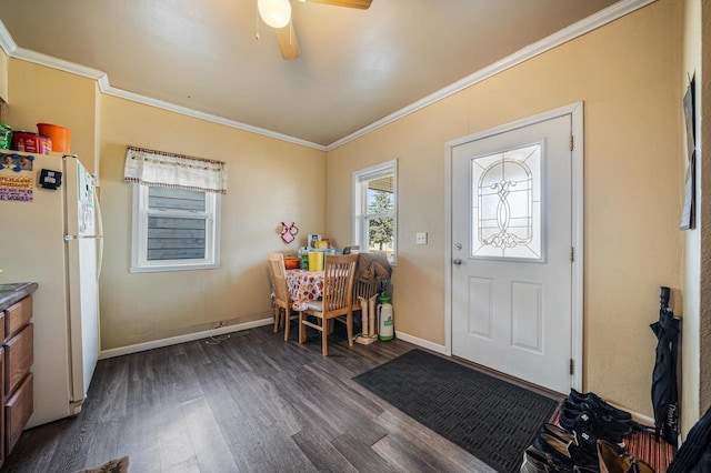 entrance foyer featuring ceiling fan, dark wood-type flooring, baseboards, and ornamental molding