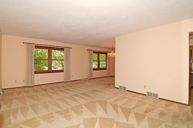 2325 Stuart Ct, Madison, WI 53704 - empty room featuring baseboards, an inviting chandelier, light carpet, and visible vents