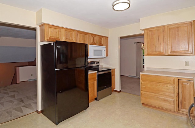 2325 Stuart Ct, Madison, WI 53704 - kitchen with stainless steel electric range, light countertops, freestanding refrigerator, white microwave, and light floors