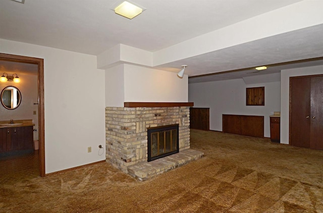 2325 Stuart Ct, Madison, WI 53704 - unfurnished living room with carpet flooring, baseboards, a brick fireplace, and a sink