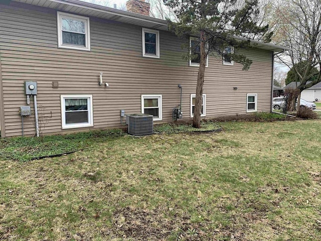 2325 Stuart Ct, Madison, WI 53704 - rear view of property featuring a lawn, cooling unit, and a chimney