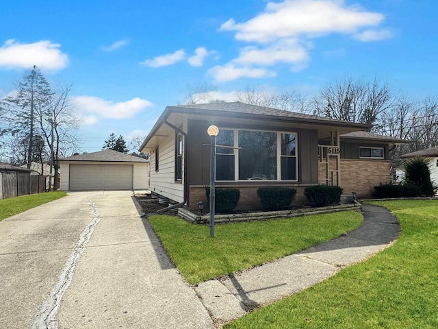 view of front of home featuring roof with shingles, an outdoor structure, a front lawn, a garage, and brick siding